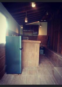 a kitchen with a green refrigerator in a room at Puri Taru Ubud in Ubud