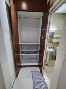 ein Bad mit einem begehbaren Kleiderschrank und einem Waschbecken in der Unterkunft Couple room with attached bathroom in Dubai