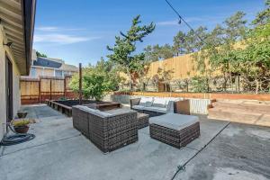 a patio with two couches and a bench at King Suite, 5 Queen beds Spacious Modern Home in Castro Valley