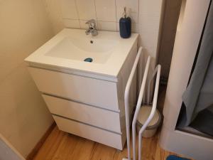 a bathroom with a sink and a toilet at Appartement silencieux avec une belle vue . in Morez