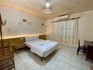 a bedroom with a white bed and a desk at Ecran Riverfront Guesthouse in Kampot