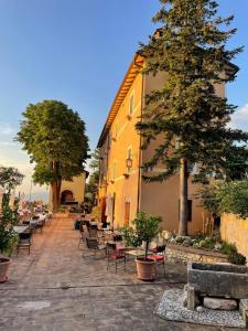 eine Straße mit Stühlen und Tischen und ein Gebäude in der Unterkunft AGRITURISMO Villino Bellavista in Spoleto