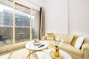 a living room with a couch and a table at Luxury 1 Bedroom On Marina Walk in Dubai
