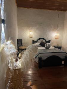 a bedroom with a bed with feathers on it at Hotel Colonial Abejorral in Abejorral