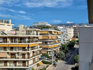 an apartment building with a green dome on top of it at Alimos Marina Sunnyhub in Athens