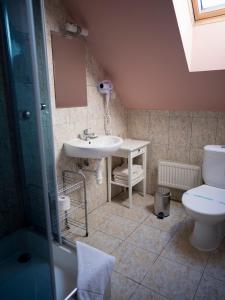 a bathroom with a sink and a toilet at Penzión ROYAL in Bytča