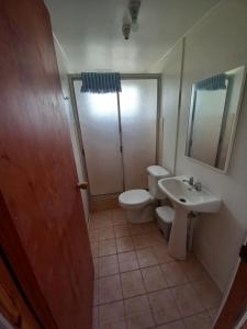 a bathroom with a toilet and a sink at Cabañas Alma Changa Atacama in Caldera