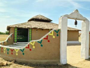 a small house with a chair in front of it at HODKA RANN STAY Resort in Bherandiāla