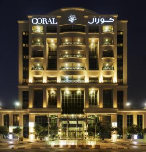 
a large building with a large clock on the front of it at Coral Dubai Deira Hotel in Dubai

