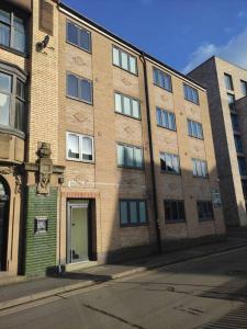 a large brick building with a door on a street at Deluxe 1 Bed Studio -2C- near Royal Infirmary & DMU in Leicester