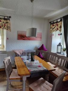 a dining room with a wooden table and chairs at Landwohnung Max&Fritz in Schauenstein