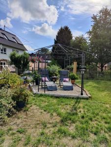 a group of chairs sitting on a patio in a yard at Landwohnung Max&Fritz in Schauenstein