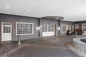 a large room with white doors and a horse in it at Protea Hotel by Marriott Johannesburg Balalaika Sandton in Johannesburg +106 photos