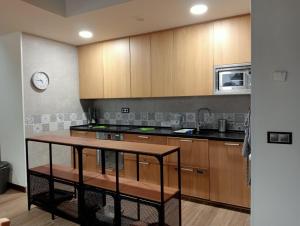 a kitchen with wooden cabinets and a counter top at Casa Rural IKIGAI, Viloria Navarra in Viloria