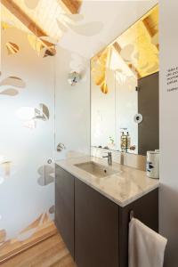 a bathroom with a sink and a mirror at Pensao O Laranjeira in Viana do Castelo