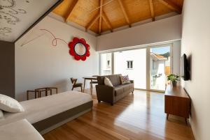 a bedroom with a bed and a table at Pensao O Laranjeira in Viana do Castelo