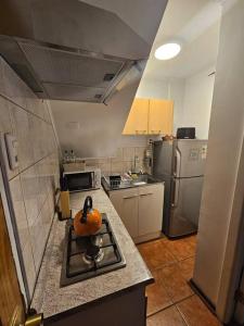 a kitchen with a pumpkin sitting on the stove at Casa cercana Mall Plaza Egaña in Santiago