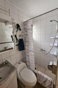 a bathroom with a toilet and a sink and a shower at Casa cercana Mall Plaza Egaña in Santiago