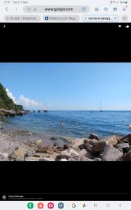 a picture of a beach with people swimming in the water at Appartament holidays Sistiana in Sistiana