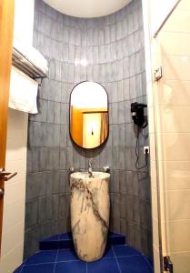 a bathroom with a sink and a mirror at Apart Hotel Banovani in Tbilisi City