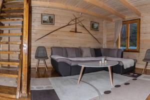 a living room with a couch and a table at Green Cottage Njegoš 