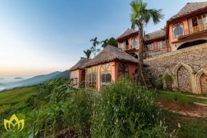 una casa al lado de una colina en Hanasa Pu Luong Resort, en Pu Luong