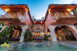 a house with a swimming pool in front of it at Hanasa Pu Luong Resort in Pu Luong