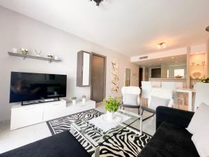 a living room with a flat screen tv and a couch at Nova Beach Apartment 41 in Gran Alacant