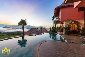 a resort infinity pool with a view of the mountains at Hanasa Pu Luong Resort in Pu Luong
