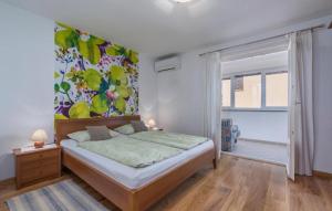 a bedroom with a bed with a painting on the wall at Guesthouse Casa Nova in Poreč