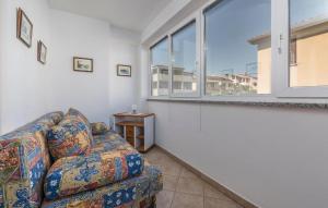 a living room with a couch and a large window at Guesthouse Casa Nova in Poreč