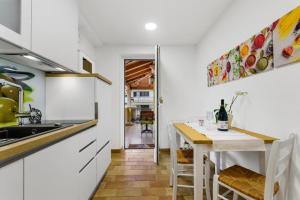 a kitchen with a table and a dining room at Guesthouse Casa Nova in Poreč