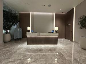a lobby with a reception desk in a building at Address Beach Resort Residence in Manama