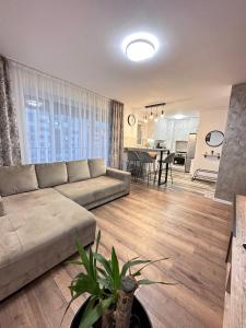 a large living room with a couch and a table at Deluxe Cozy Apartments - Coresi Mall #Brasov in Braşov