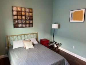 a bedroom with a bed and a picture on the wall at Chilled Pad 2 Blocks from the French Quarters in New Orleans