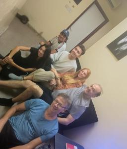 a group of people posing for a picture in a room at orange hostel in Dubai