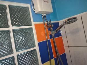 a shower in a bathroom with a shower head at Hopi Cadushi Apartment in Santa Cruz