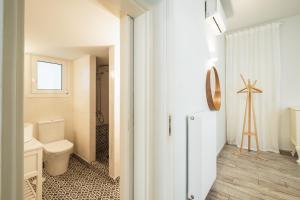 a bathroom with a toilet and a sink at Central5 Boutique Apartments with Common Garden Next to Metro in Athens
