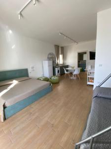 a large bedroom with a bed and a kitchen at G’S HOME in Margherita di Savoia