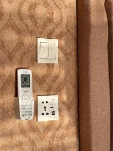 un mando a distancia y dos interruptores en una pared en Wadi Rum Golden Valley en Wadi Rum