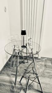 a glass table and chairs in a room at Lily CA in Cagliari