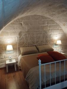 ジョヴィナッツォにあるGigò Homeの石壁のベッドルーム1室(ベッド1台付)