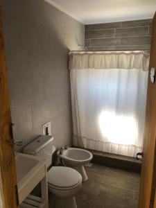 bagno con servizi igienici bianchi e lavandino di casa quinta caballito blanco a Chascomús