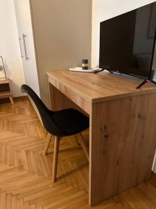 a wooden desk with a television on top of it at Cozy Faliro home in Piraeus