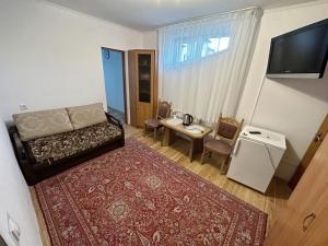 a bedroom with a bed and a table and a television at Magnolia Truskavets in Truskavets