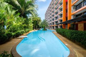 a swimming pool in the middle of a building at Mountain View Mai Khao Beach Condotel in Ban Bo Sai Klang