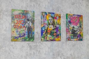 a group of four paintings on a wall at YourHouse на Си Синхая 22 близко к Меге in Almaty