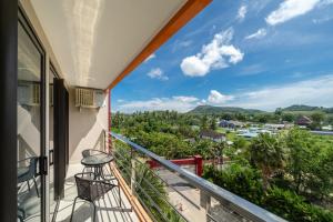 a balcony with a view of a town at Mountain View Mai Khao Beach Condotel in Ban Bo Sai Klang