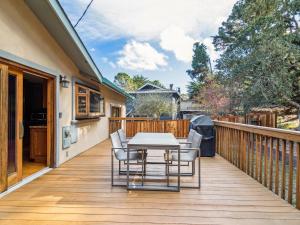 a wooden deck with a table and chairs on it at Coastal Serene Retreat in the Heart of Monterey! home in Monterey