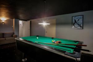 a pool table in a living room with a bill at Willa Bliski in Szczyrk